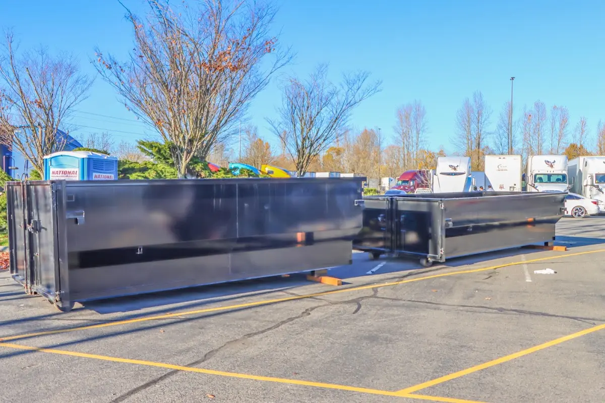 Professional dumpster rental service with roll-off container on residential driveway in Huntingdon